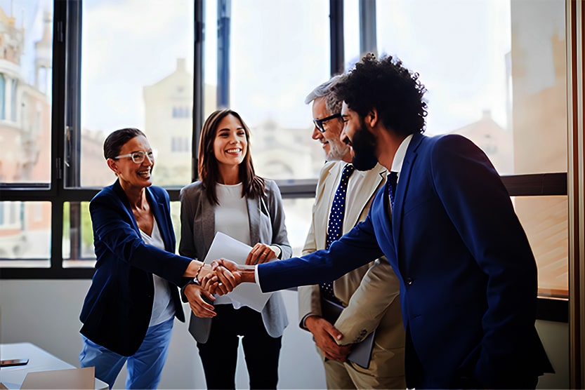 A diverse group of business people shaking hands at work